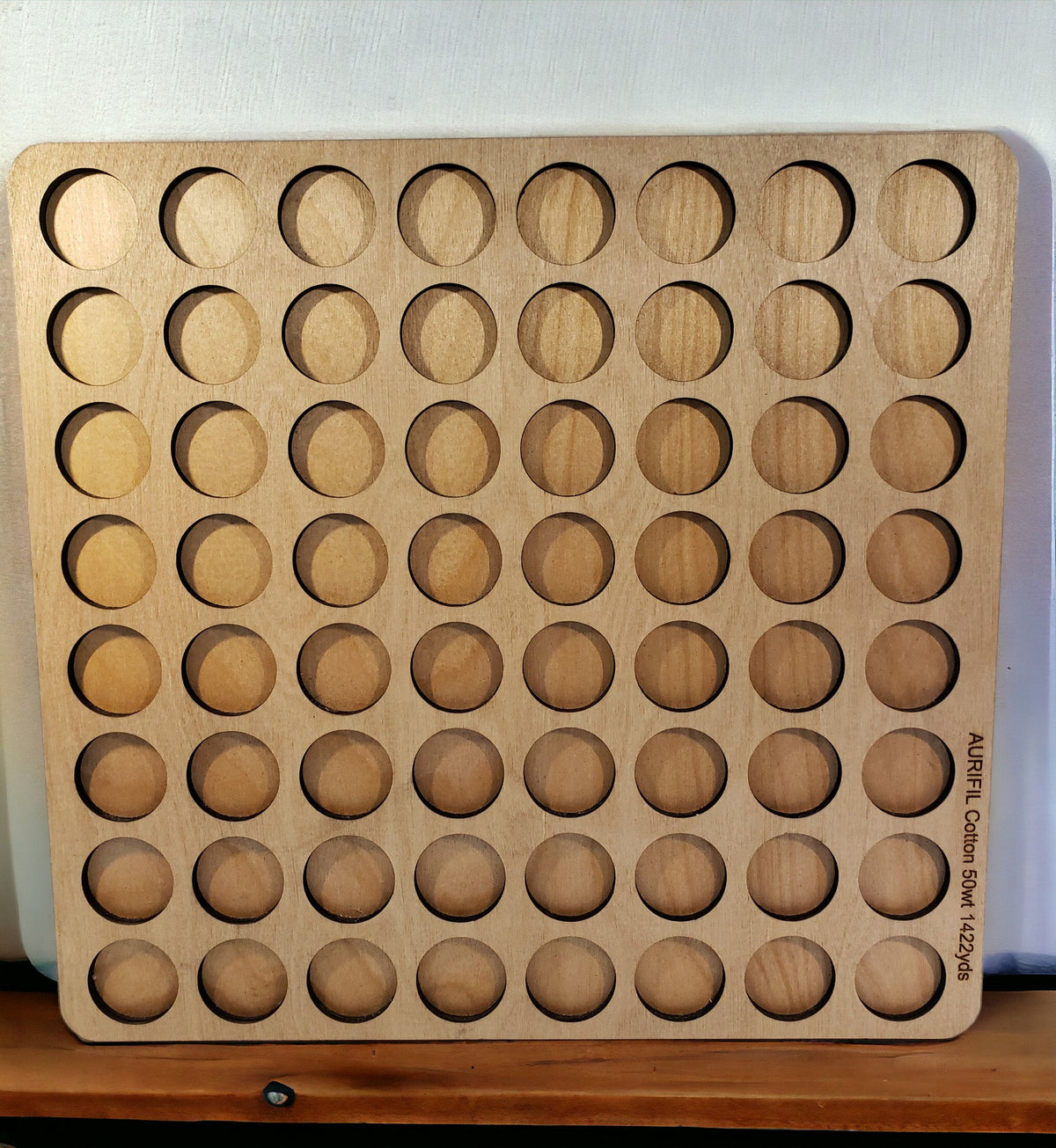 Aurifil Unnumbered Thread Storage Tray, 64 Spools — empty tray showing circular spool openings