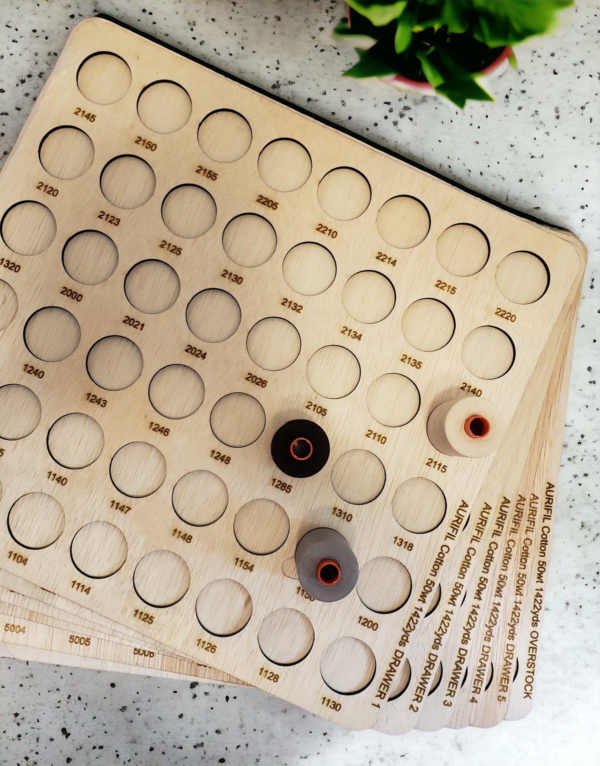 Aurifil Numbered Thread Storage Trays, Set of 6 — overhead view of engraved trays with sample spools