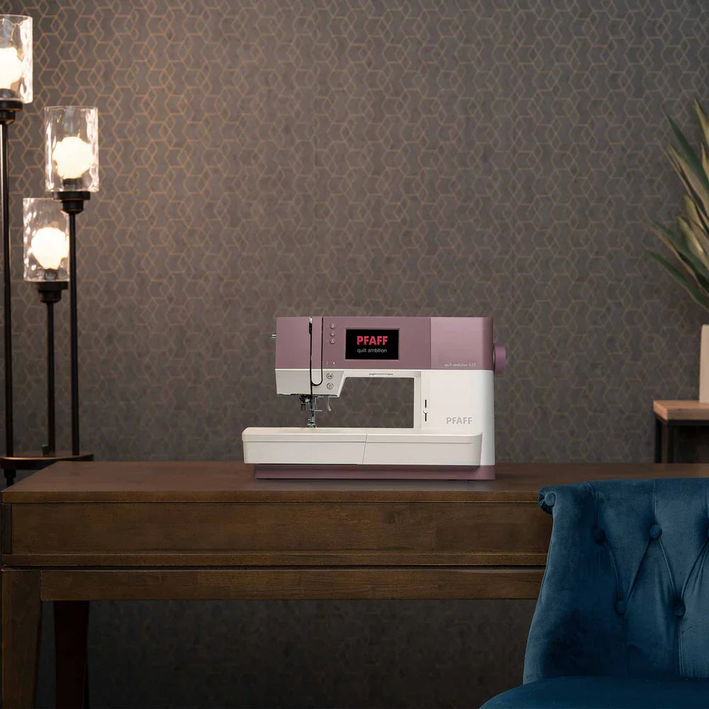 Sewing machine on a wooden table with decorative wall and lamp in the background