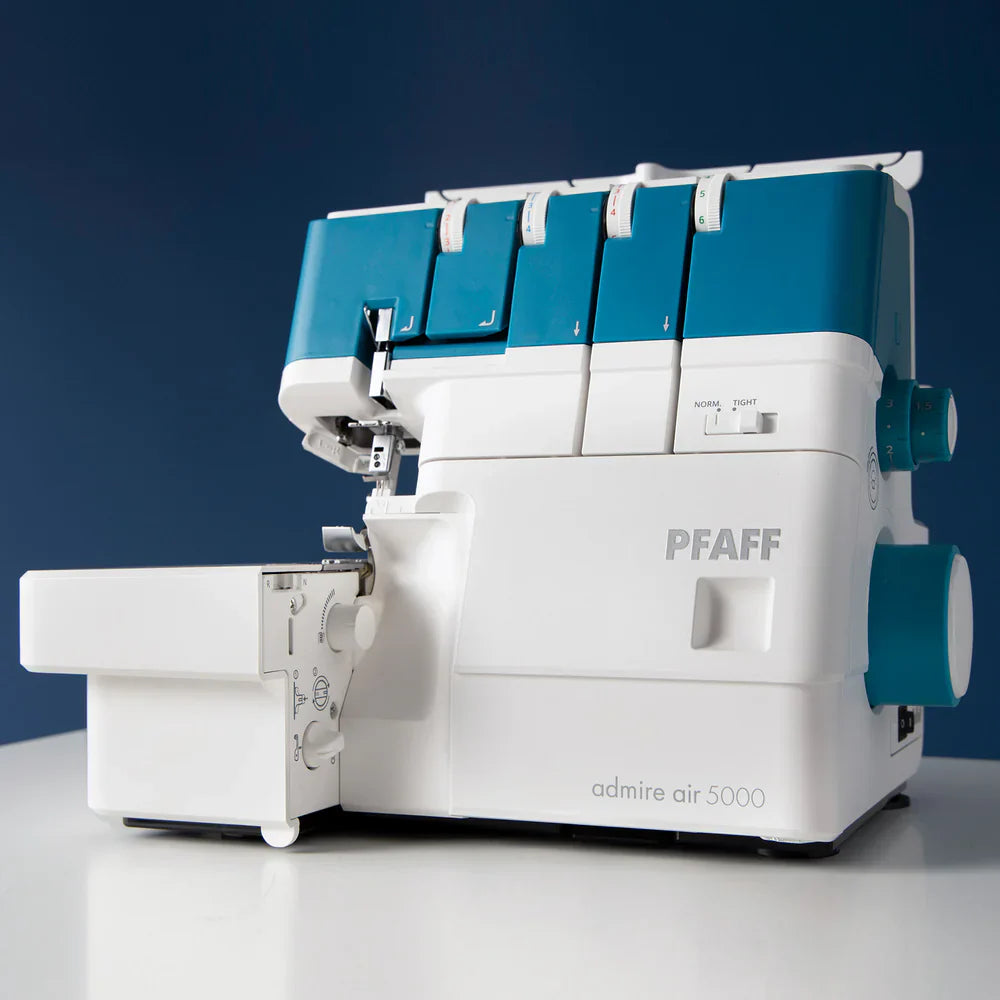 PFAFF admire air 5000 sewing machine on a white surface with a blue background