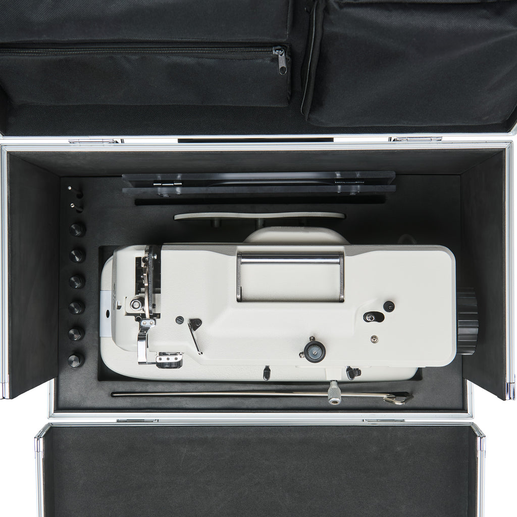 Top-down view of sewing machine and accessories organized inside the CudaCase
