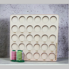 DIME Medley Variegated Thread Storage Tray, 30 Spools — numbered tray standing behind variegated thread samples