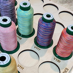 DIME Medley Variegated Thread Storage Tray, 30 Spools — close-up of variegated spools and engraved color numbers
