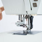 Close-up of a sewing machine with a white background