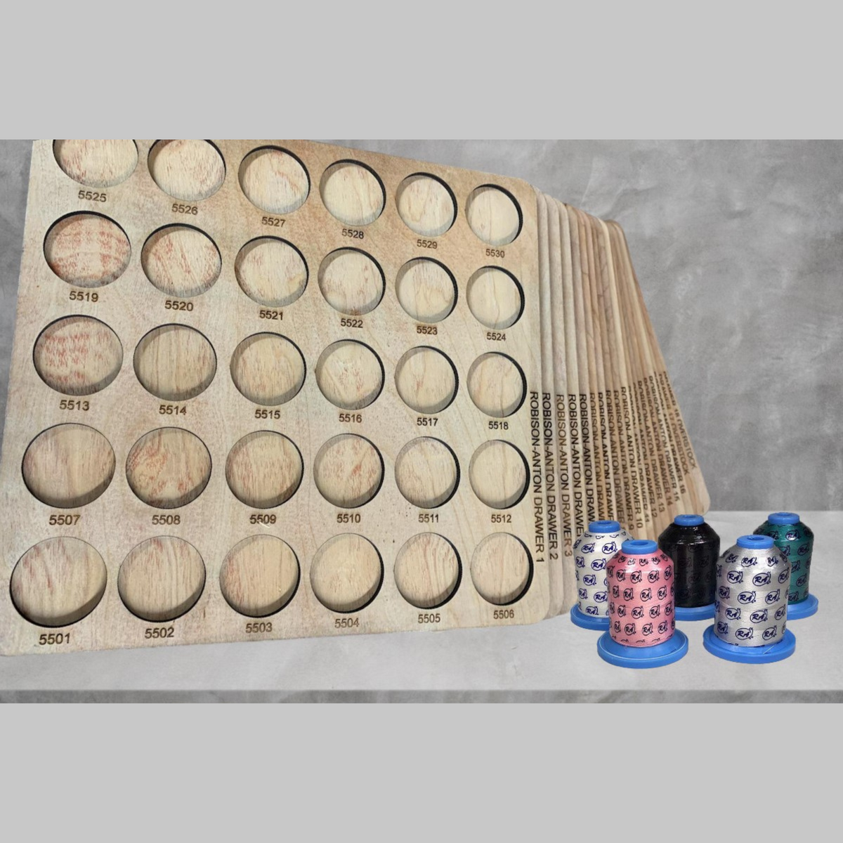 Robison-Anton Numbered Thread Storage Trays, 540 Spools — angled view of numbered trays and sample spools