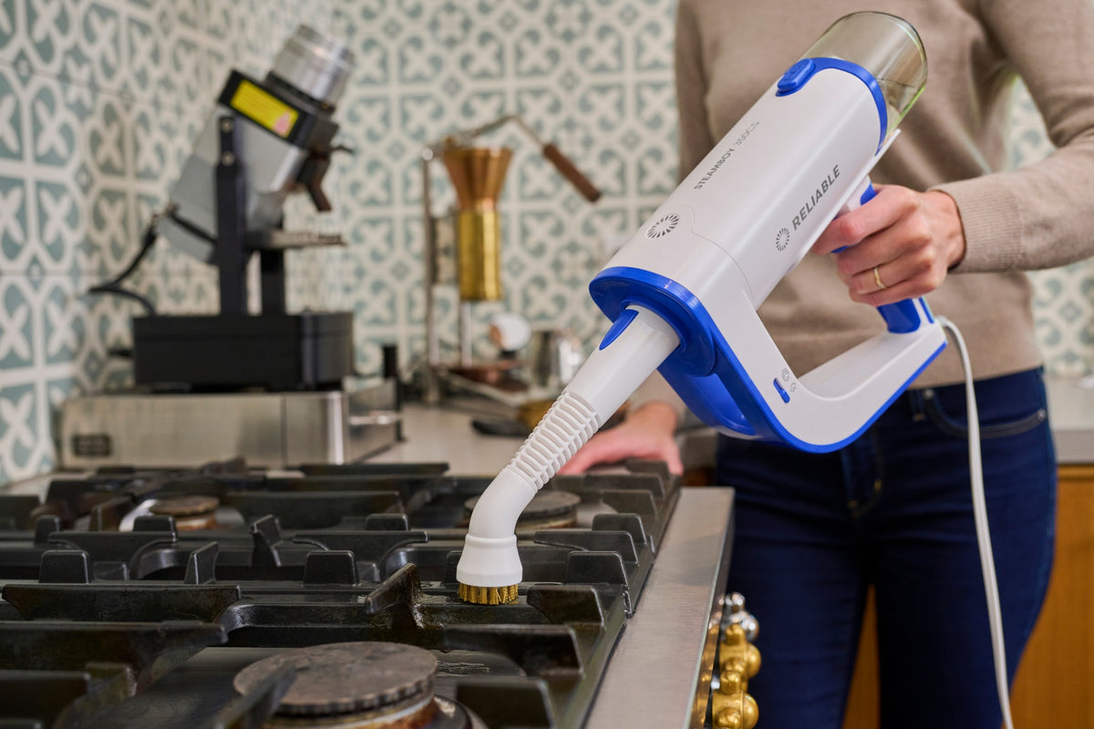 Steamboy Plus 350CS brush cleaning a gas cooktop