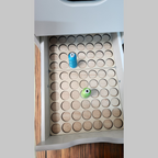 IKEA ALEX 5-Drawer Thread Storage Tray Inserts — angled view of an open drawer with one sample spool