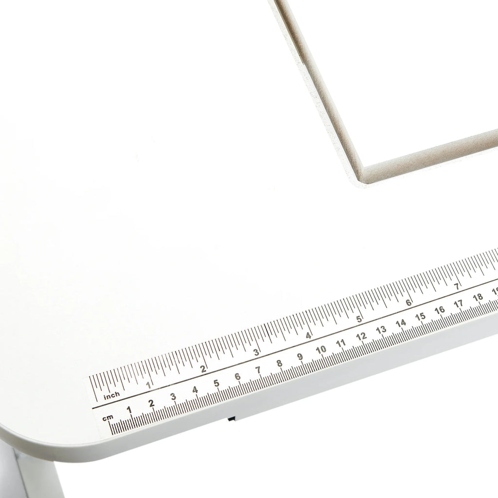 Close-up of the Arrow Gidget II Sewing Table 611 built-in ruler decal for accurate sewing measurements.