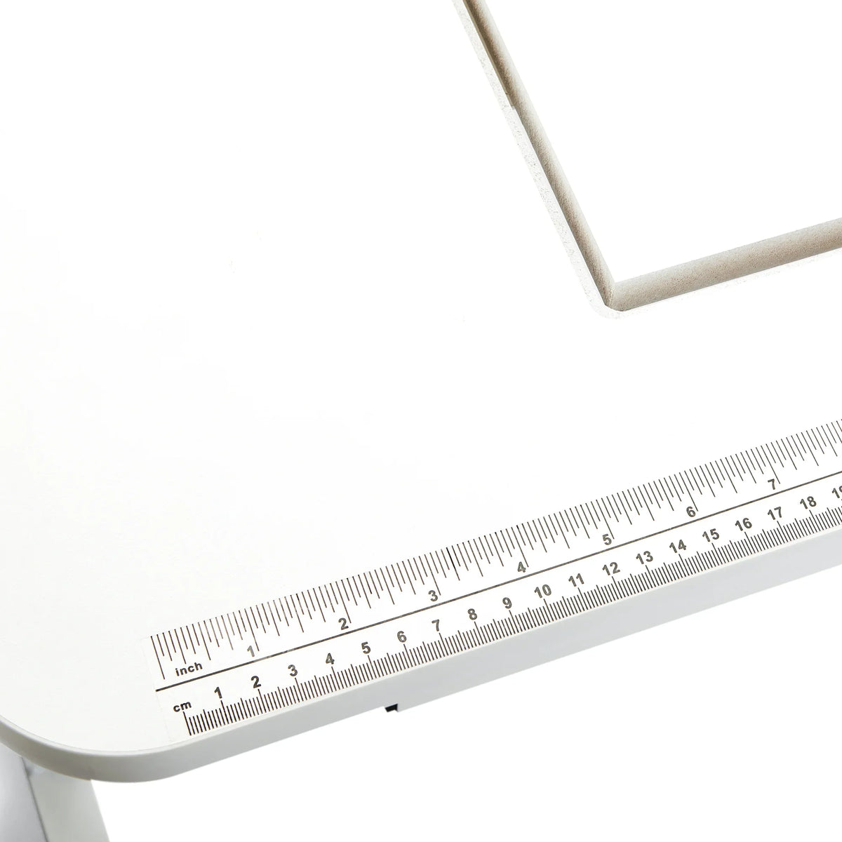 Close-up of the Arrow Gidget II Sewing Table 611 built-in ruler decal for accurate sewing measurements.