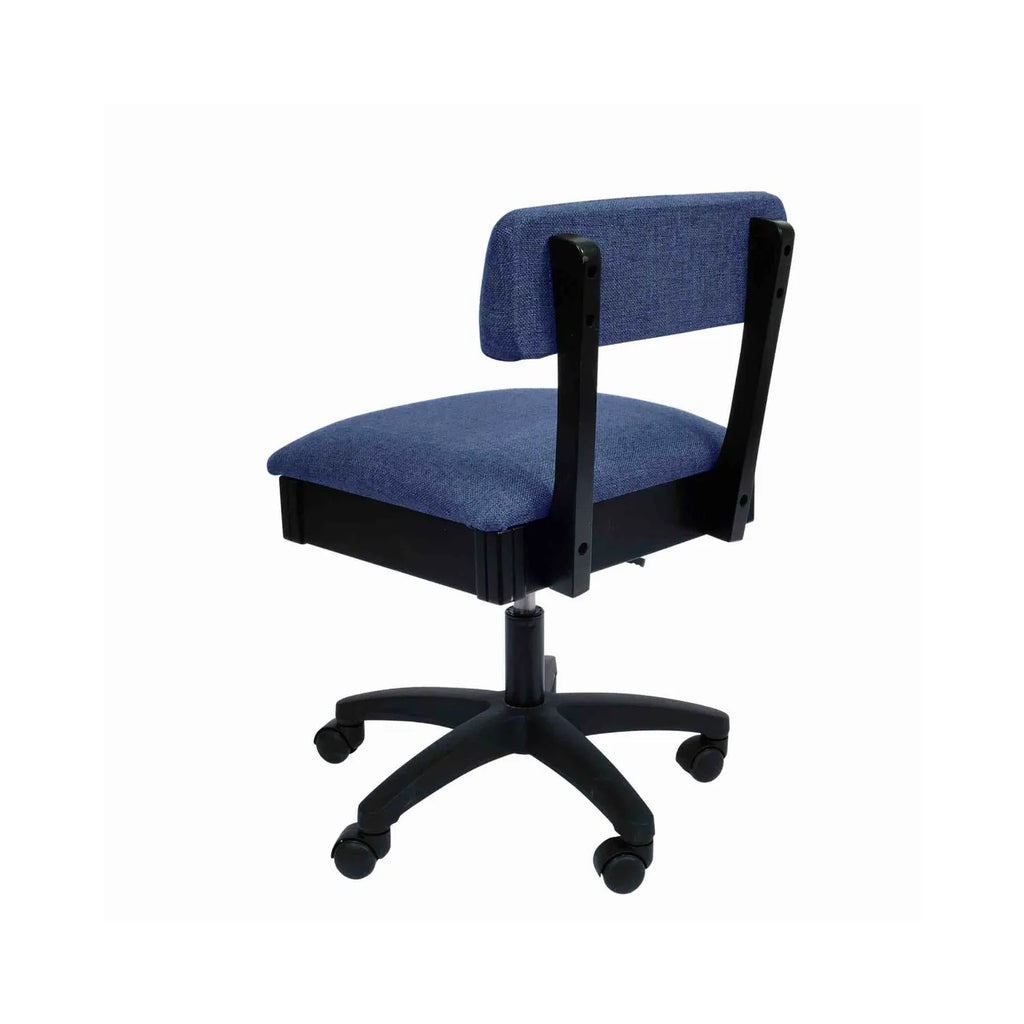 Arrow Duchess Blue Hydraulic Sewing Chair – rear angle view showing deep blue woven fabric upholstery, supportive backrest, and five-wheel caster base.