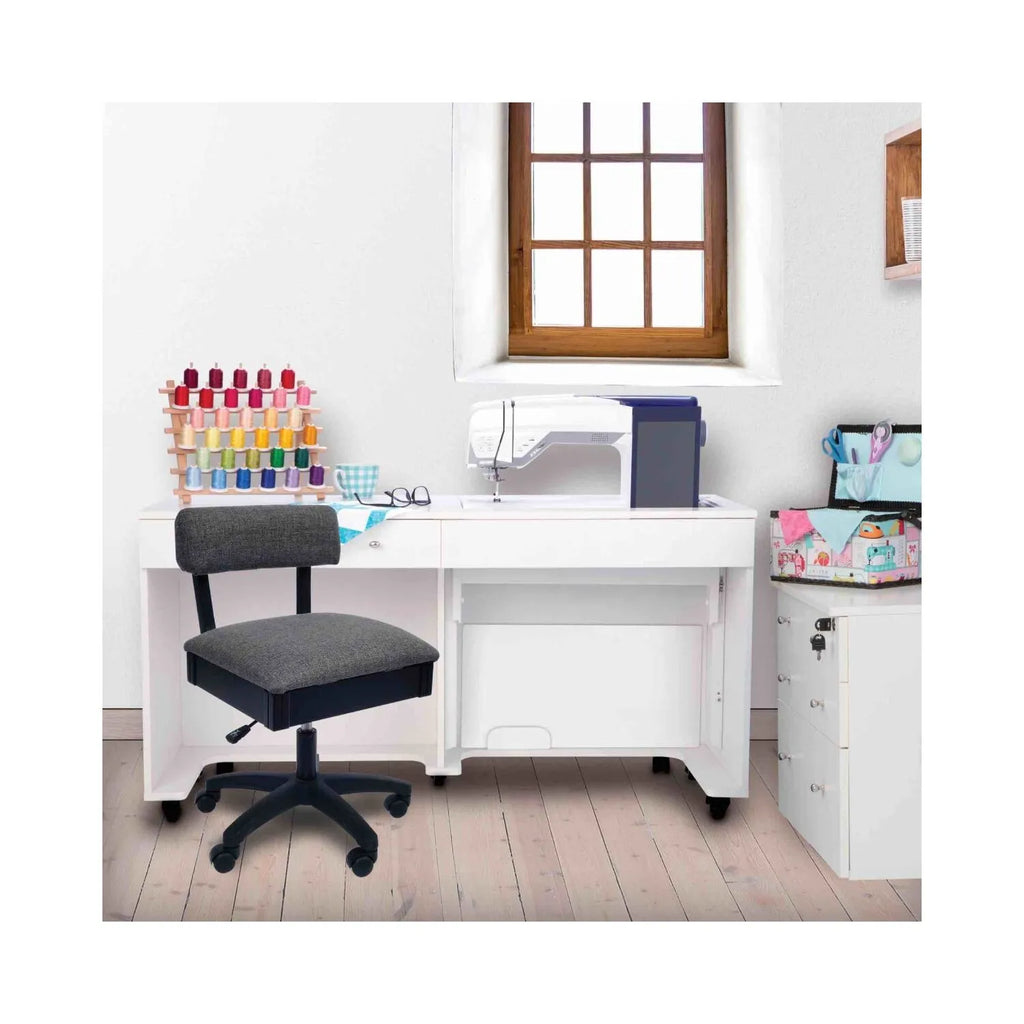 Arrow Lady Gray Hydraulic Sewing Chair in sewing room setup – ergonomic gray swivel chair paired with white sewing cabinet and machine.