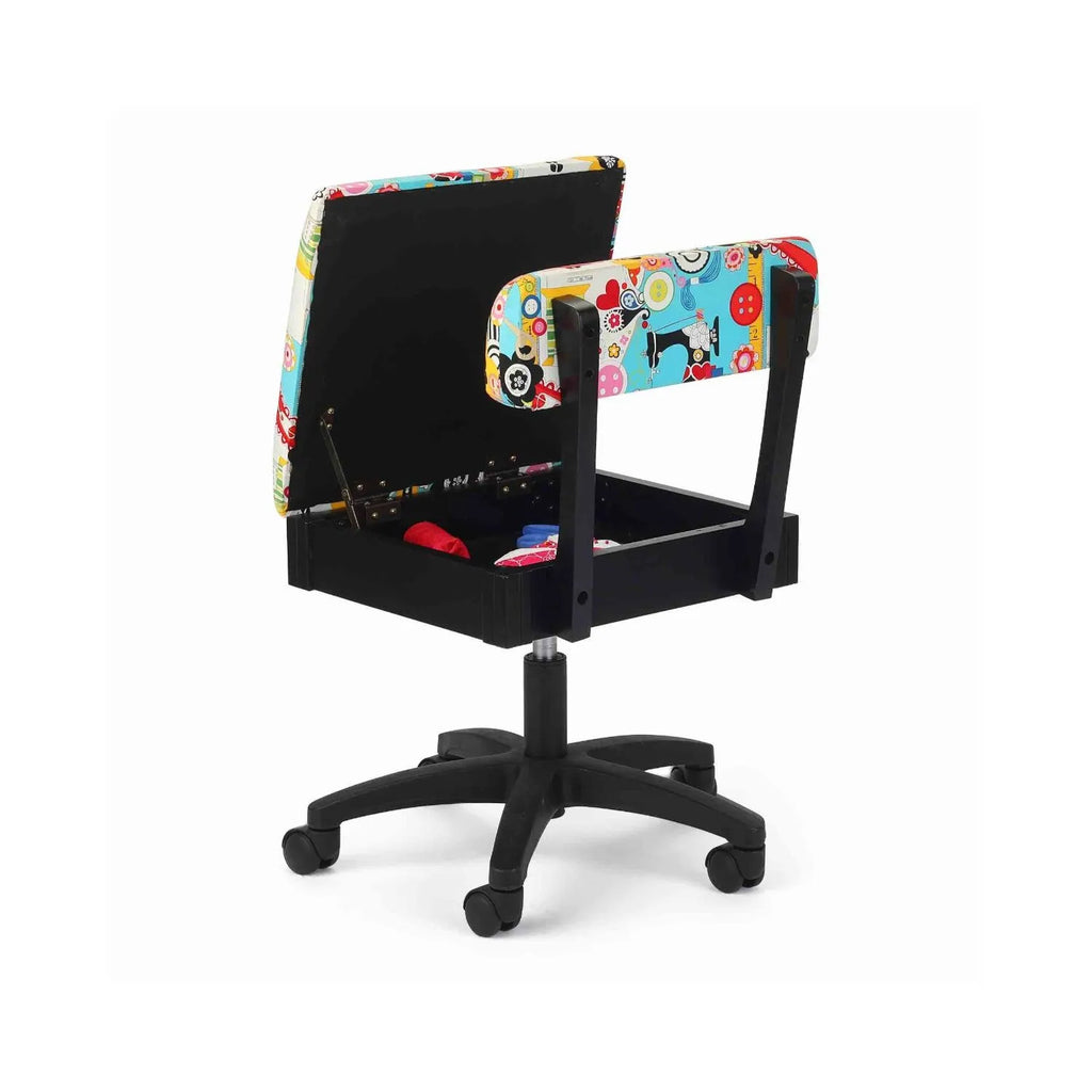 Arrow Sew Wow Hydraulic Sewing Chair – open seat storage compartment displayed with sewing notions, featuring vibrant sewing-themed upholstery.