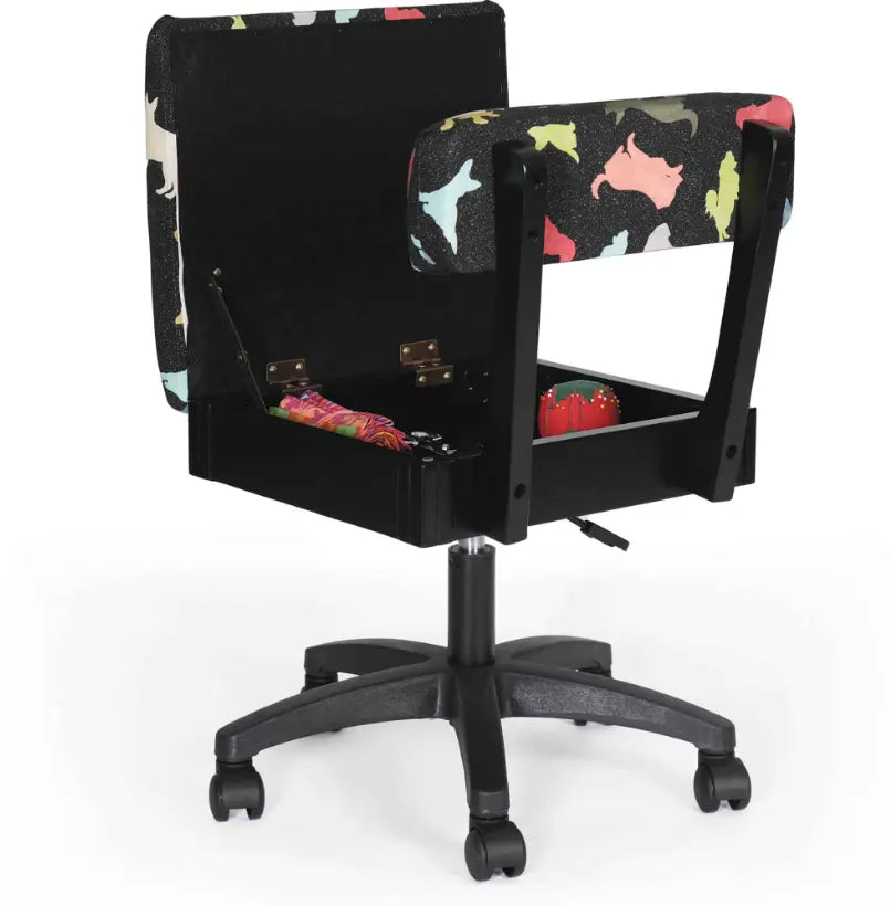 Arrow Dog’s Meow Hydraulic Sewing Chair Black – open storage seat display with crafting tools inside and multicolor dog-pattern cushioning.