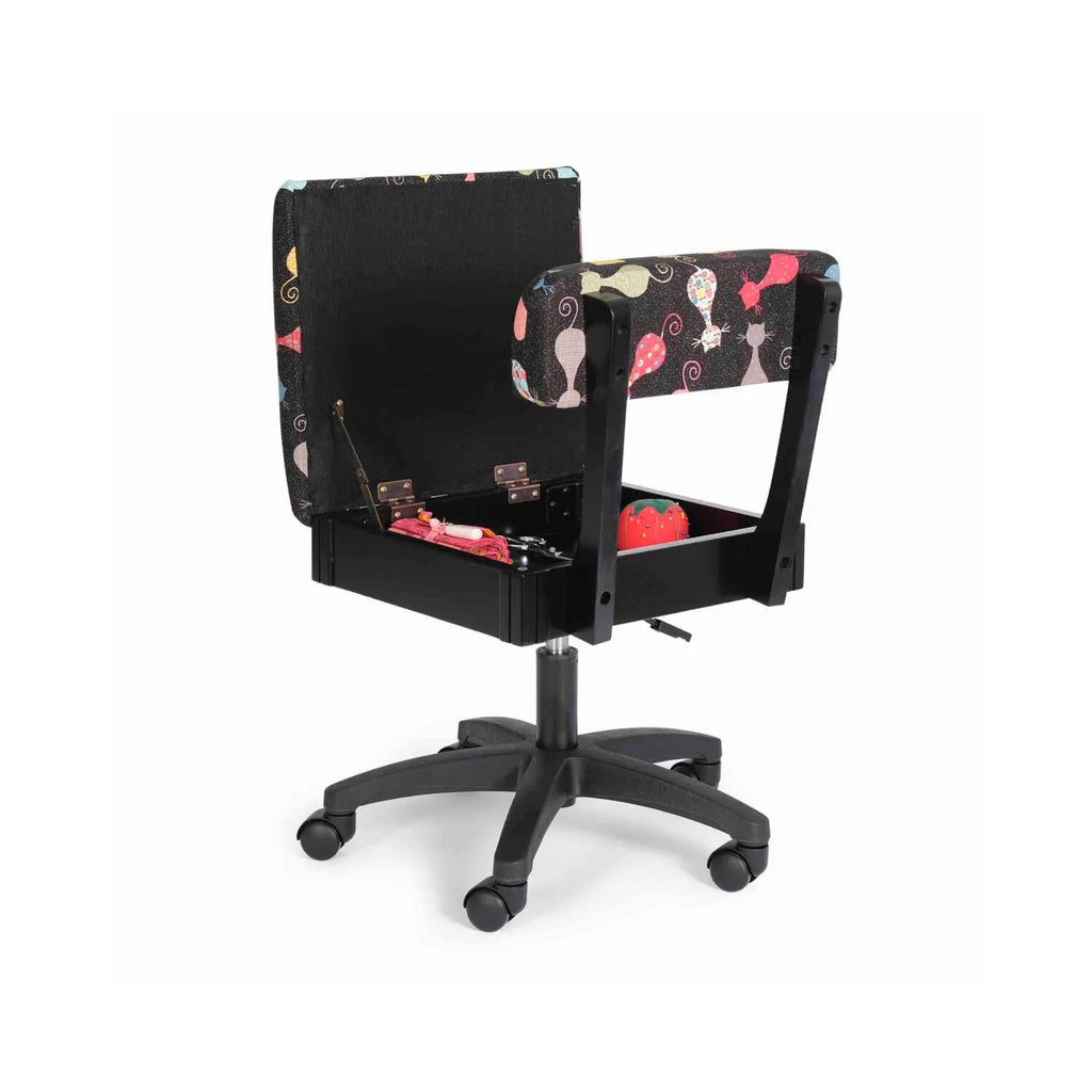 Arrow Cat’s Meow Hydraulic Sewing Chair Black – open seat storage compartment displayed with sewing notions inside, featuring cat-themed upholstery.
