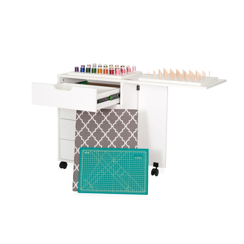 Arrow cabinet drawer unit extended with fabric storage and cutting mat pulled out for sewing organization.