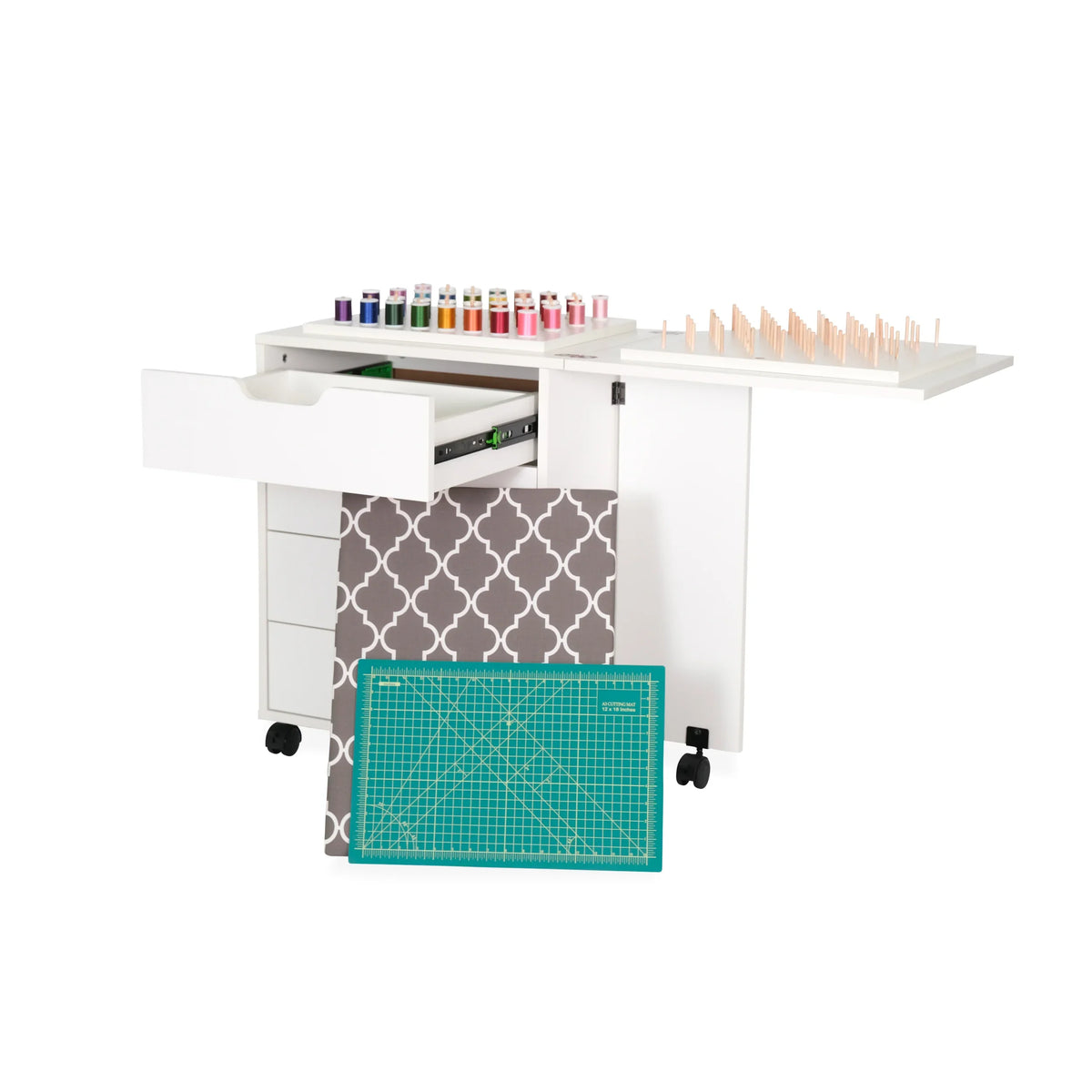 Arrow cabinet drawer unit extended with fabric storage and cutting mat pulled out for sewing organization.
