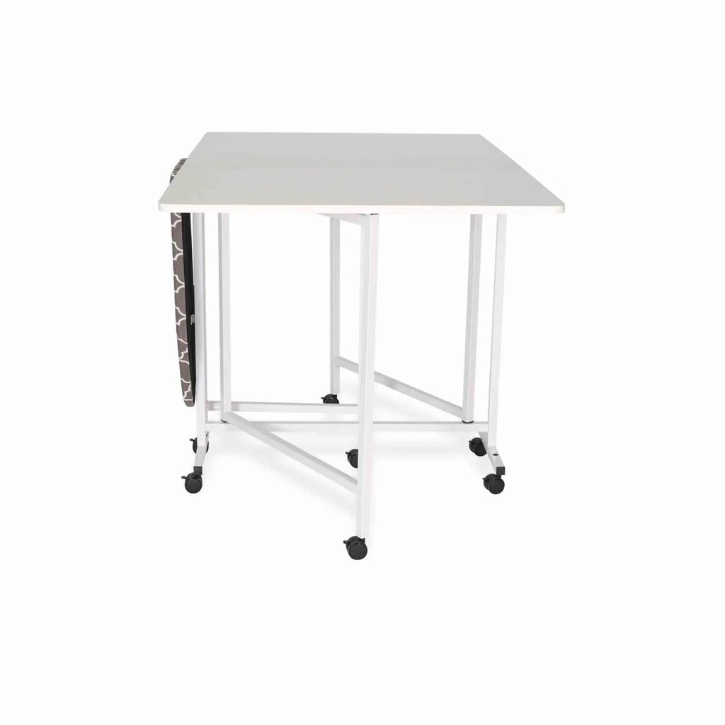 Arrow Millie Cutting & Ironing Table 3311 shown folded with ironing board stored vertically and mobile caster base.
