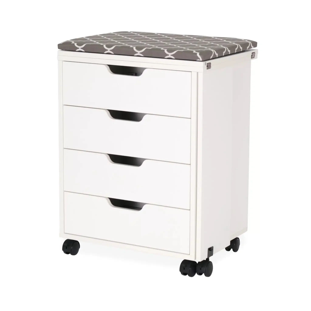 Arrow Shirley Storage Cabinet White 441 closed view showing four storage drawers, cushioned ironing board top, and mobile caster wheels for compact sewing room storage.