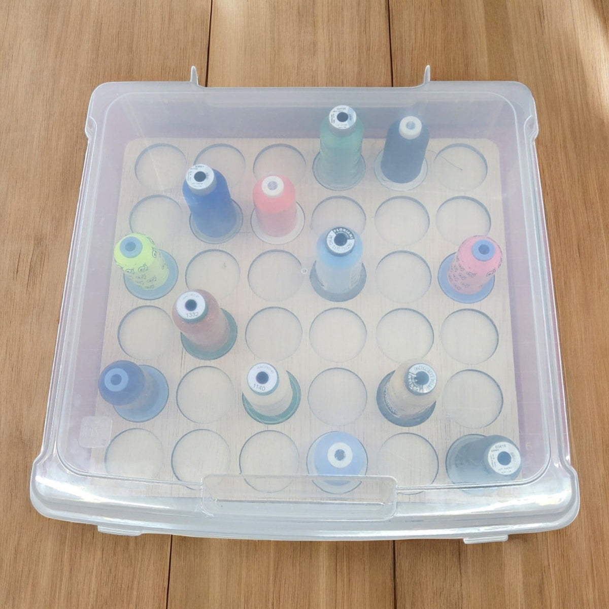 Blank Embroidery Thread Storage Tray, 36 Spools — tray and spools beneath a closed clear case lid
