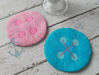 Finished pink and turquoise in-the-hoop button coasters