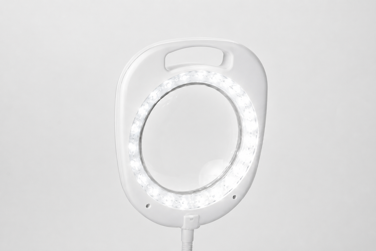 Close-up of the illuminated 5-inch magnifying lens on the white Daylight UN1080 lamp