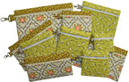 Eleven finished green and floral in-the-hoop zippered bags in square and rectangular sizes