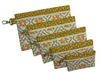 Set of six green and floral in-the-hoop zippered bags in graduated rectangular sizes