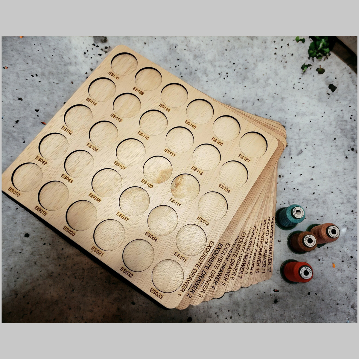Exquisite Embroidery Thread Storage Trays, 360 Spools — empty numbered trays with spools beside them