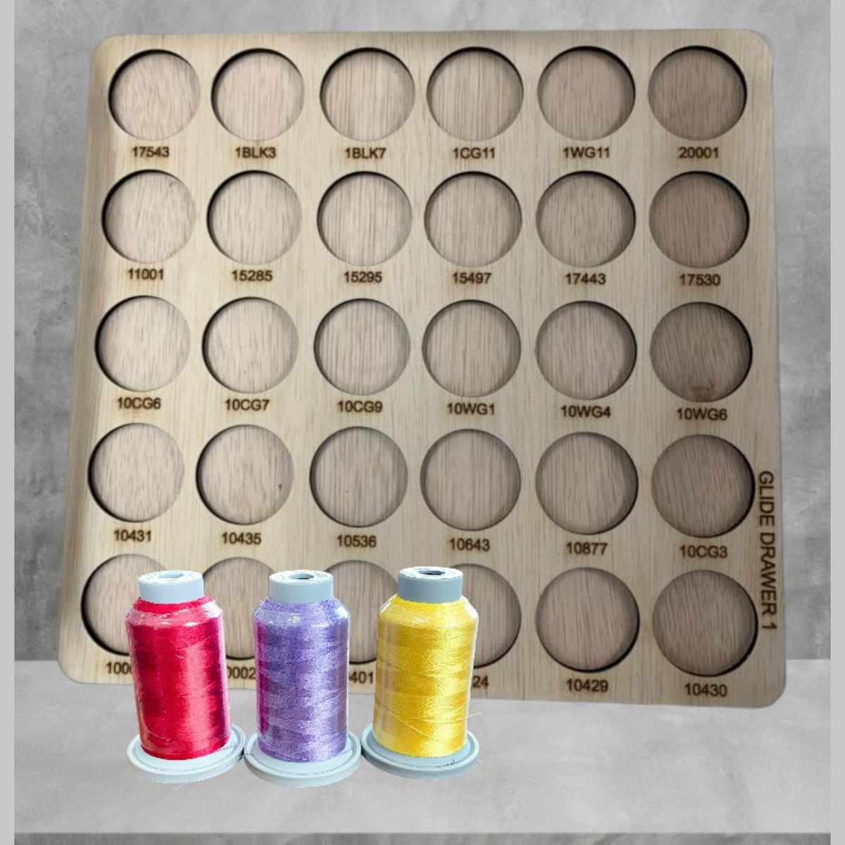 Glide Numbered Thread Storage Trays, 450 Spools — numbered wooden trays with pink, purple and yellow spools