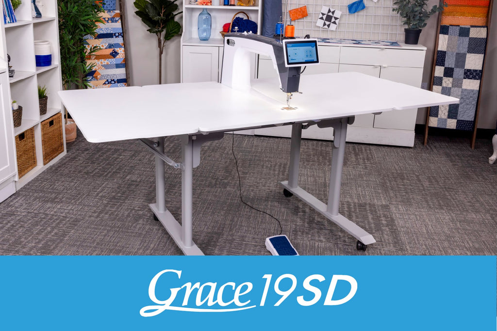 Grace Company 19SD Sit-Down Longarm Quilting System — complete setup in a sewing room