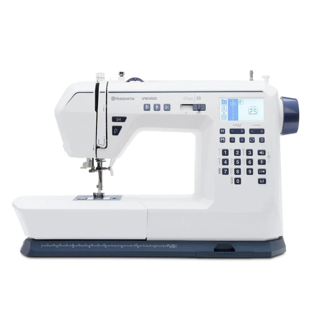 Husqvarna Viking Onyx 30 computerized sewing machine front view showing LCD screen, stitch selection keypad, and wide sewing bed