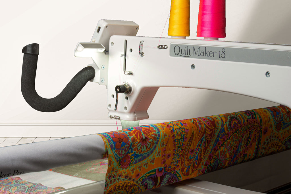 Janome Quilt Maker 18 manufacturer machine and frame view; fabric shown for demonstration