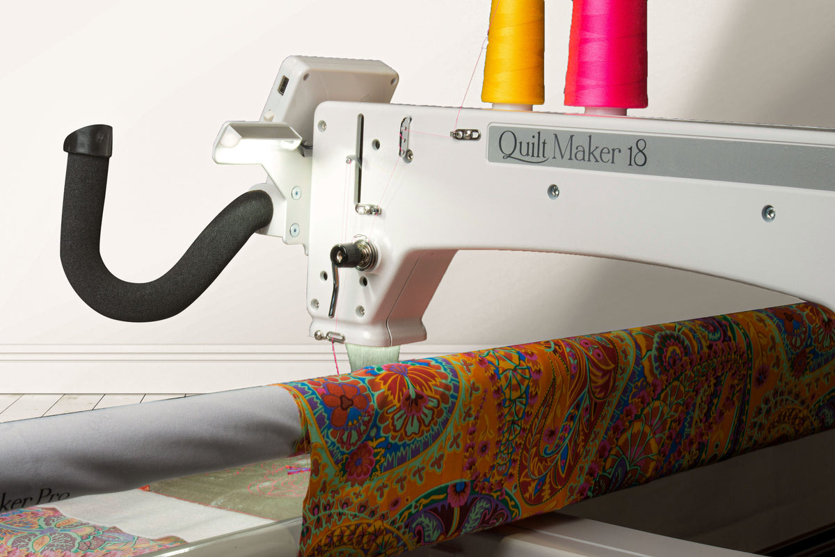 Janome Quilt Maker 18 manufacturer machine and frame view; fabric shown for demonstration