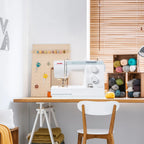 Janome Sewist 721S sewing machine set up in a modern craft room with yarn storage and sewing tools, ideal for hobby and home sewing.
