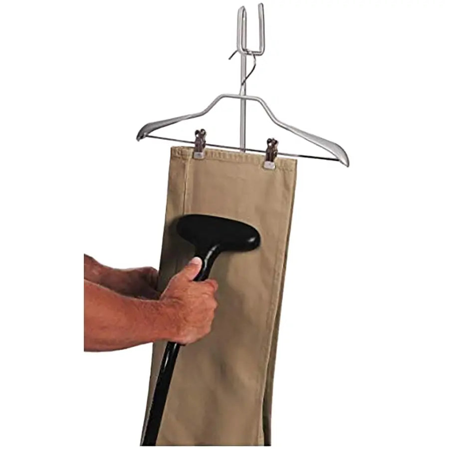 Jiffy J-2 clothing steamer being used to remove wrinkles from a pair of khaki pants on a hanger