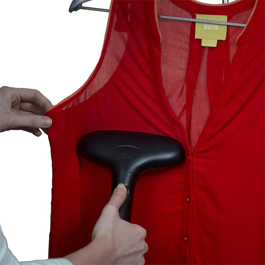 Jiffy J-2 garment steamer gently steaming wrinkles out of a delicate red blouse on a hanger