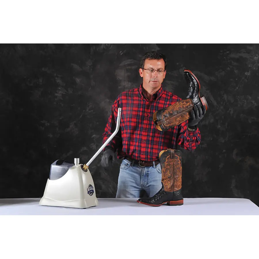 Professional using Jiffy 2535 SteamBreaker to soften and break in leather boots