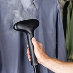 Jiffy J-4000 steamer in use, steaming wrinkles out of a shirt with the standard plastic steam head.