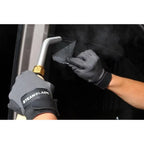 Technician using the Jiffy SteamBlade to lift and remove automotive window tint with targeted steam