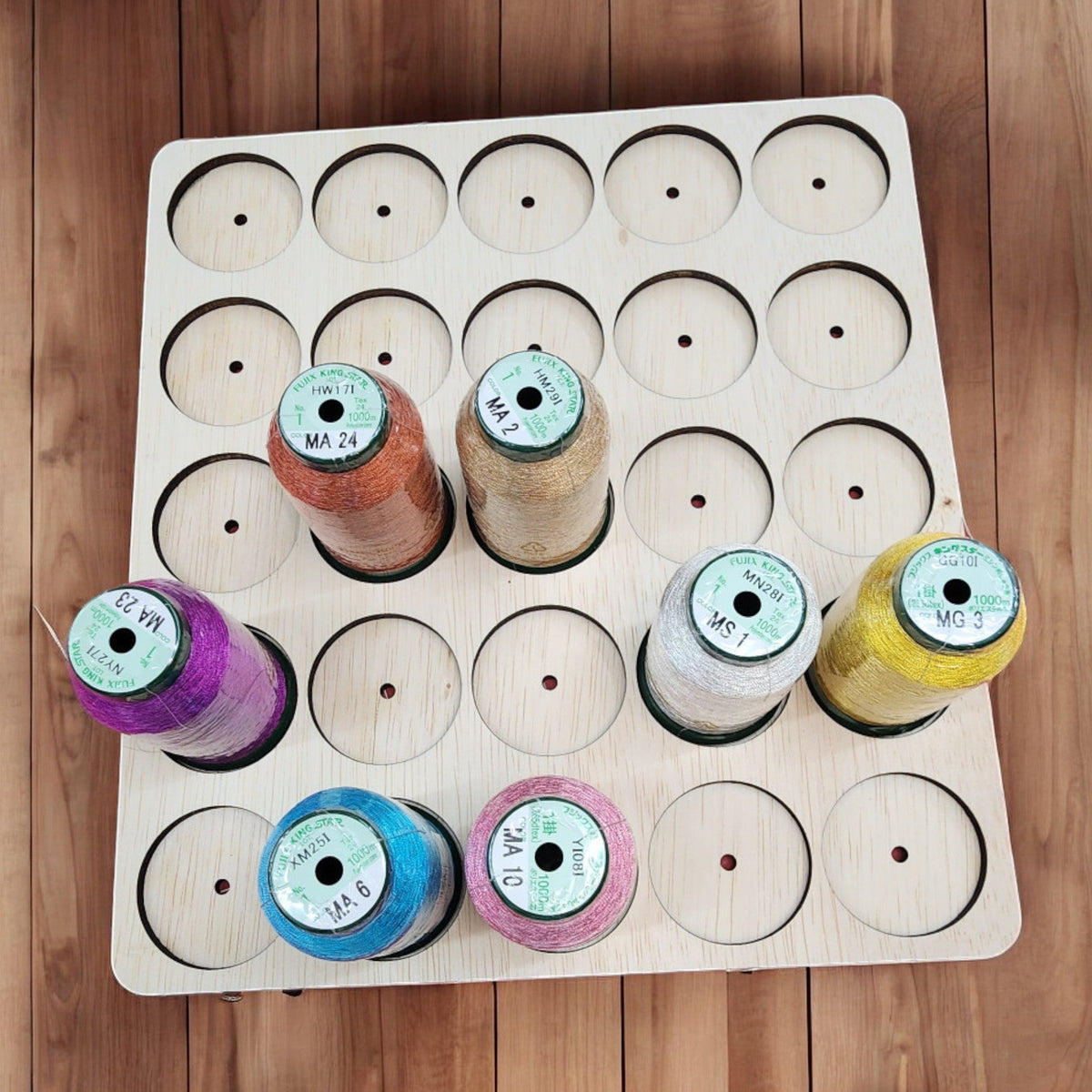 IKEA KALLAX Thread Storage Tray Insert — metallic spools organized in a tray with dowel holes