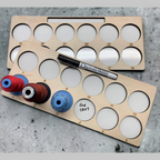 Two numbered project trays organizing embroidery thread in 24 stitching positions