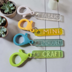 Four scissor identification fobs labeled Fabric, Mine, Embroidery, and Craft