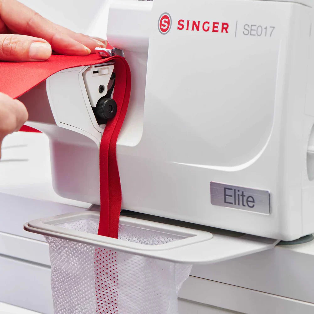 SINGER SE017 Elite serger free arm sewing red fabric with attached scrap catcher for clean and efficient trimming