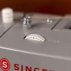 Detail view of SINGER Heavy Duty 6600C adjustable presser foot pressure dial for sewing thick and lightweight fabrics