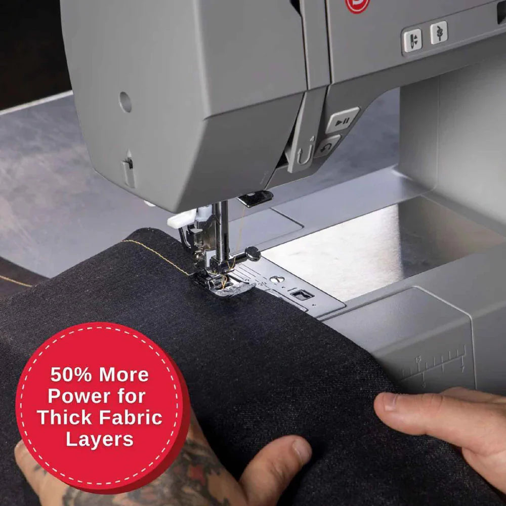 SINGER Heavy Duty 6700C sewing machine stitching thick fabric layers with enhanced motor power and stability
