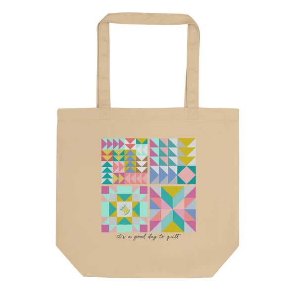 Natural-color Pastel 2 tote with a grid of colorful triangular quilt blocks above It's a good day to quilt lettering.