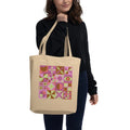Model carrying a natural-color tote with retro geometric quilt blocks in fuchsia, lime green and cream.
