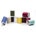 Ten solid-color Sulky cotton spools arranged in a group, including blue, cream, black, white, yellow, brown, red, green and aqua.