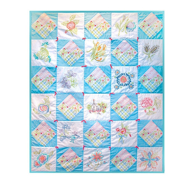 Finished vintage-style quilt with turquoise borders, pastel patchwork blocks and embroidered floral panels.