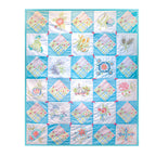 Finished vintage-style quilt with turquoise borders, pastel patchwork blocks and embroidered floral panels.